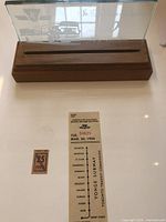 Etched glass panel mounted in carved wooden holder with TTC bus design and inscriptions.