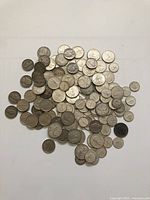 Pile of mixed Canadian and US silver coins on white background