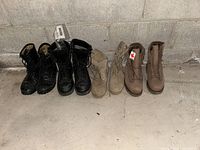 Four pairs of Canadian Forces army boots in black, beige, and tan colors shown side by side on a concrete floor against a cement wall, some with tags.