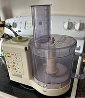 Side view of Braun Multipractic food processor showing base unit with control buttons and attached transparent bowl with feed chute.