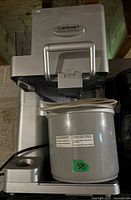 Front view of the Cuisinart ICE-45 soft serve ice cream maker showing the main unit and 1.5-qt removable container with handle and labels.