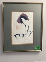 Framed artwork titled "Eternal Conflict" showing the full piece with abstract figure and orb in muted color tones.