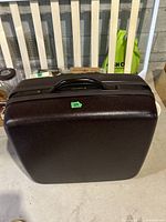 Vintage Samsonite suitcase, hard case, brown, viewed from top with handle, showing condition and seal of case