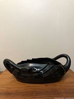 Full view of the black swan planter showing shape, size, and finish