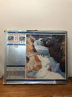 Front of the book slipcover showing artwork of a waterfall and title 'Tranquility & Turbulence The Life and Work of Walter J. Phillips'