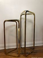 Front view of both brass tables side by side