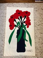 Full view of entire textile print showing red poppies, green leaves, navy vase against cream background