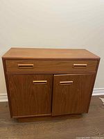 Front view showing drawer and two doors