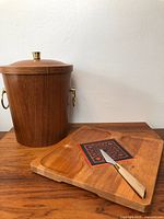 Photo showing full view of teak ice bucket with lid, cheese platter with inset, and cheese knife