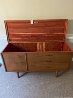 Storage chest open showing cedar-lined interior and wood grain lid detail.