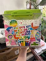 Full view of plastic container with labeled front showing the contents and the brand CreateBasics. It shows the kit includes 138 pieces and various dye colors.