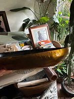 Side angle showing the bronze-tone exterior curved surface of the tray