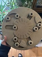 Top view of the round dog puzzle showing paw shaped rotating lids covering treat compartments.