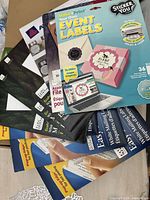 Photo showing multiple packs of StickerYou event labels and assorted file organizing sheets