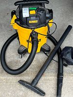 Overall view of Dewalt vacuum with hose, wand, bag and attachments