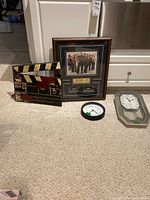 Group shot of framed Sopranos display, clapper board, round clock, octagonal clock