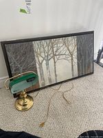 Framed canvas print and lamp shown together for scale