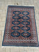 Full view of rug showing size, design, fringe