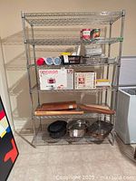Full view of six-shelf chrome wire rack with assorted contents (not included) showing size and design