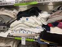 Shelved stack of mixed towels showing colors and textures