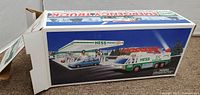 Side view of the closed 1994 Hess Emergency Truck box showing colorful package graphics including a truck, limousine, and gas station illustration.