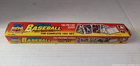 Box of 1991 Topps Micro Baseball Cards with 792 picture cards, the complete set offered in a long rectangular box with bright yellow and orange colors and images of various cards on the sides and ends.