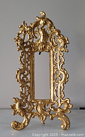 Frontal view of ornate gilt easel frame