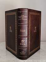 Front and spine of full leather bound Franklin Library book showing gold embossing and text.