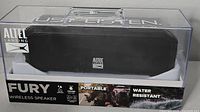 Front and side view of Altec Lansing Fury wireless speaker in clear plastic box showing branding, model, and water resistance feature on packaging.