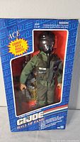 Front view of GI Joe Hall of Fame "Ace" action figure in original box showing figure in green pilot uniform with included combat rifle.