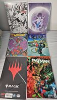 Photo shows assorted comics including Unholy, Static Shock, Batgirl, Batman, Magic: The Gathering.