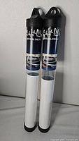 Two Salt Life decal tubes standing against a wall, showing the full product packaging and branding.