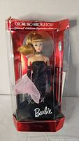 Front view of Solo In The Spotlight Barbie in box wearing black evening gown, showing damage to top of box.