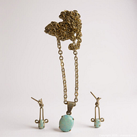 Necklace and two earrings arranged upright to show design and opals
