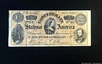 Obverse of 1864 CSA $100 note showing portraits and serial number