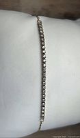 Full bracelet laid flat showing continuous diamond row