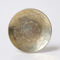 Front view of brass bowl showing full etched dragon design