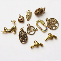 All ten gold-tone charms laid out showing individual designs and relative sizes
