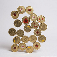 Obverse view of 23 colorized Canadian quarters with various commemorative designs