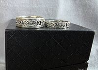Front view of both Celtic knot rings on box