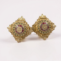 Front view of both gilt brass and enamel star pips