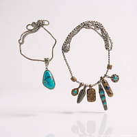 Both necklaces displayed: teardrop turquoise pendant necklace on left, Shore Thing charm necklace on right