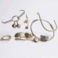 Group view of bracelets, rings, link bracelet, clover pieces