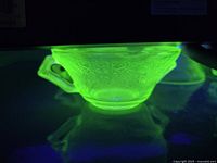 Dessert bowl glowing under UV light showing uranium content