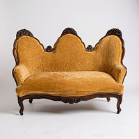 Front view of triple camelback sofa showing carved walnut frame and gold velvet upholstery