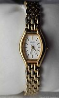 Front view of Seiko gold-tone women’s watch on cushion showing dial and bracelet