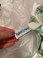 Close-up of the My Brest Friend label sewn on the fabric nursing pillow cover.