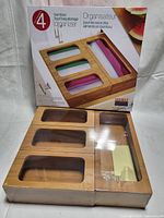 Boxed bamboo food bag storage organizer showing packaging and bamboo finish.