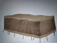 Brown rectangular cover for patio dining set visible on furniture.