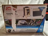 Photo of front of boxed Coleman POWERCHILL Thermoelectric Cooler showing branding, model number 5644, and key features including 40 Quart capacity, 44 cans, ice less technology, power usage 12V 5 amps 60 watts.